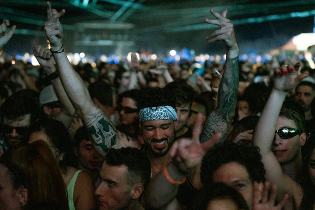 What Is True Worship? 5 Questions That Reveal Your Devotion 2 Concertgoers raising hands in emotional expression, symbolizing human passion and devotion.